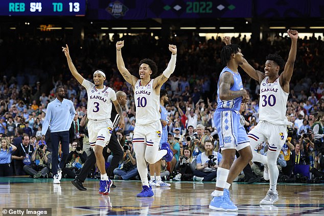 Dajuan Harris Jr. #3, Jalen Wilson #10 and Ochai Agbaji #30 of the Kansas Jayhawks celebrate after defeating the North Carolina Tar Heels 72-69 during the 2022 NCAA Men's Basketball Tournament National Championship at Caesars Superdome on April 4 -- No. 67 on the list