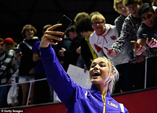 Livvy posed with fans after a PAC-12 game against Utah at the Hunstman Center in Salt Lake City.