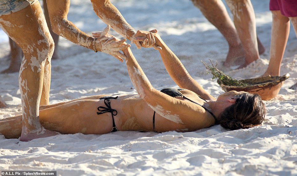 This looks interesting - here she was helped up as she lay calmly on the sand next to a bowl.