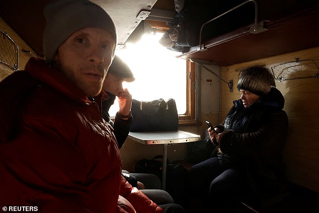 Residents of Soledar sit on an evacuation train to Dnipro, as Russia's attack on Ukraine continues, in Pokrovsk, Ukraine, January 8, 2023