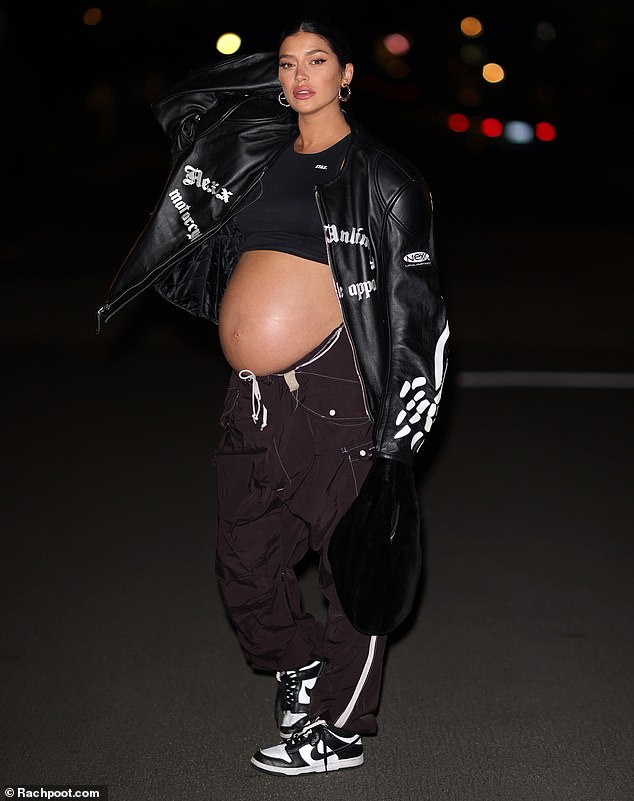 Baby bump: The model, 35, who announced she was expecting during Miami Swim Week in July, showed off her baby bump in a black crop top, low-cut baggy joggers and sneakers