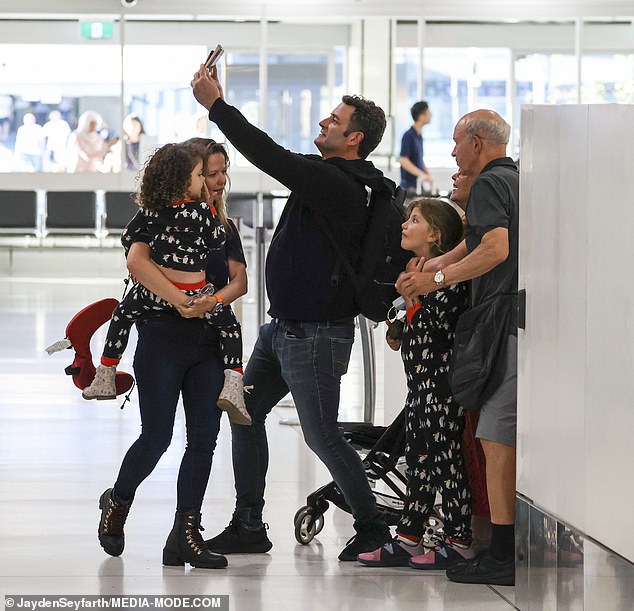 After an emotional farewell moment, the happy family snuggled up close and posed for a selfie.