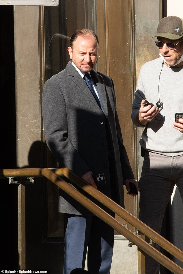 Fisher's look: Stevens was seen wearing a blue suit with a dark gray coat for the funeral scene in New York City.