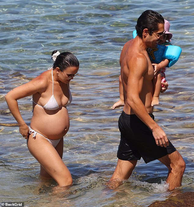 The genetically blessed couple basked in the sun as they waded through the shallows and relaxed on the rocky shoreline.