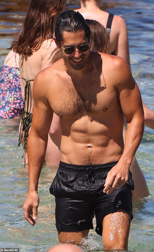 Tai, 32, who is best at playing Andy Barrett on Home And Away, meanwhile showed off his ripped six-pack and bulging biceps in a pair of black swim shorts.  =