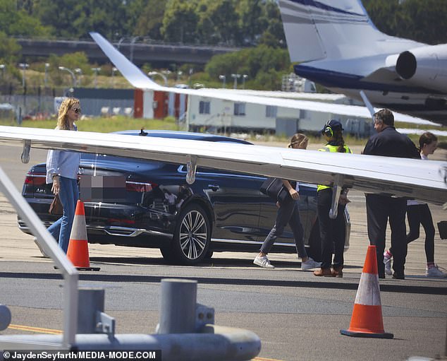 The couple's children Sunday, 14, and Faith, 12, carried backpacks when they boarded the plane with the famous parents.