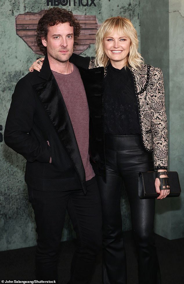 Classic look: Her better half donned a black blazer over a pink T-shirt.  He added black pants and matching shoes to his outfit.