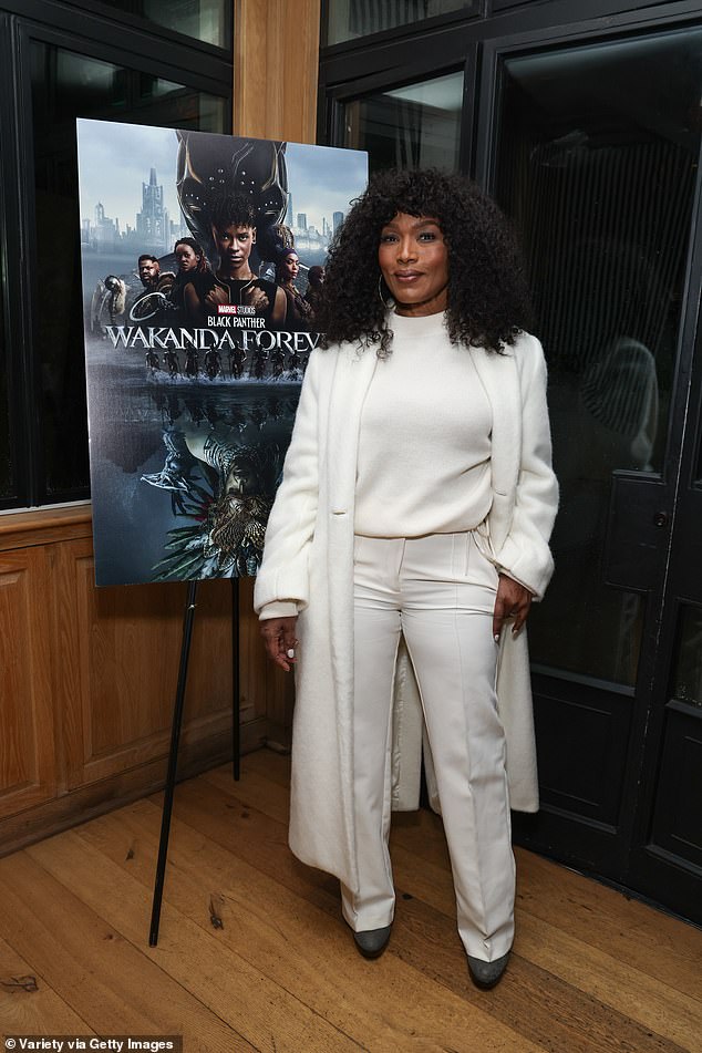 Angela's look: Bassett stepped out in an all-white ensemble, featuring a sleek white top tucked into pleated white pants.