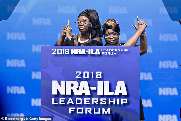 Diamond and Silk social media personalities Lynnette Hardaway and Rochelle Richardson gesture while speaking at the National Rifle Association in 2018