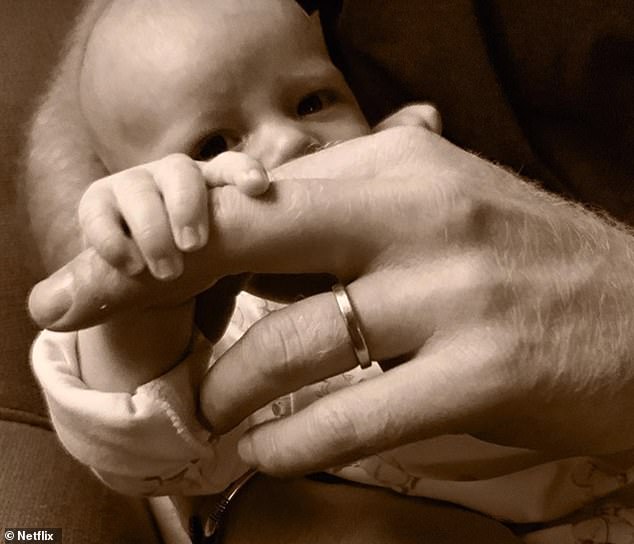 Archie imagining his father's hand shortly after his birth.  Harry has admitted that he took several puffs of laughing gas to calm his nerves when Meghan gave birth for the first time.