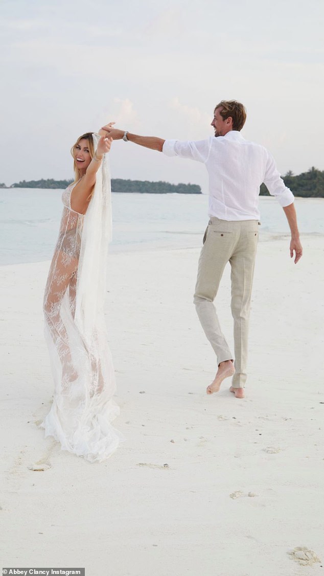 Party time: Peter twirled his wife in the sand as they posed for the stunning photos