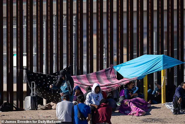 A short distance from where President Biden was strolling along a 'sanitized' stretch of border fence in El Paso, the migrants continued across the Rio Grande into the US.