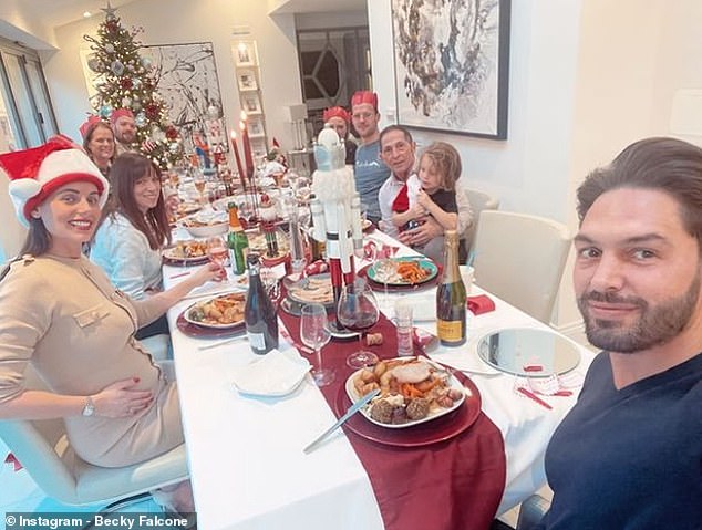 Family: Former TOWIE star Mario also took a selfie of them about to tuck into their delicious roast dinner where Becky proudly cradled her bump