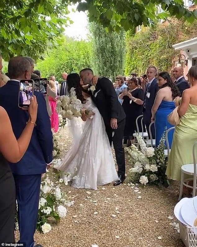 The couple shared a kiss to applause from their family.