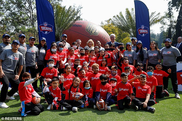 Jill Biden poses for a photo with students participating in the Tochito NFL flag football event at the United States Ambassador's residence in Mexico City, Mexico.