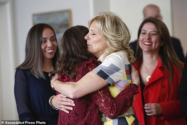 Jill Biden hugs a woman during an event on women's empowerment