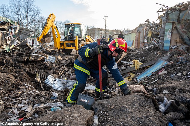 Personnel conduct work at the scene following a Russian attack on the territory of the market in Shevchenkove village of Kharkiv yesterday