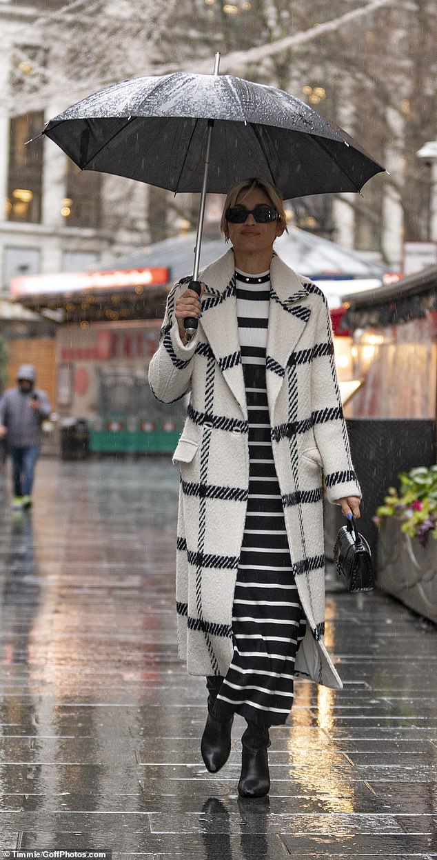 Staying warm: Amanda was joined by her Heart FM co-star Ashley Roberts, 41, who opted for a long wool coat with a striped maxi dress