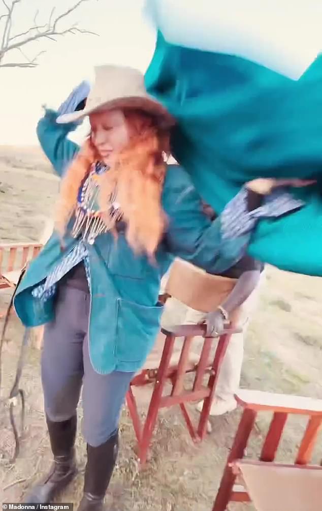 Fashionista: Madonna got into the spirit of things, dressed in skinny pants with boots and a patterned shirt, while donning a waterproof jacket and an oversized turquoise shawl