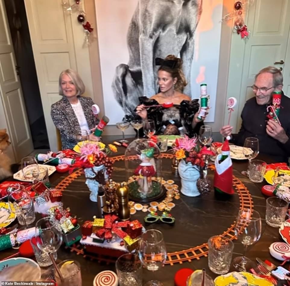 Festive fun: Kate enjoyed Christmas dinner at the castle with a train in the middle of the table