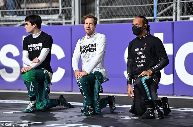 F1 drivers Lance Stroll (left), Sebastian Vettel (centre) and Lewis Hamilton take a knee