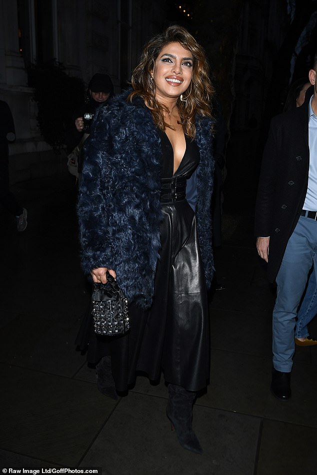 All eyes on her: The actress, 40, arrived at Piccadilly Circus for the opening of Superdrug on Tuesday and cut a glamorous figure in a black leather jumpsuit and blue fleece coat