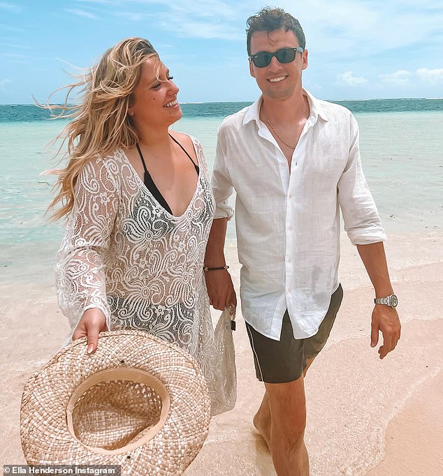 Bliss: Another image from her Christmas album showed them enjoying a romantic walk on the beach holding hands, where Ella was wearing a black bikini and a white patterned dress.