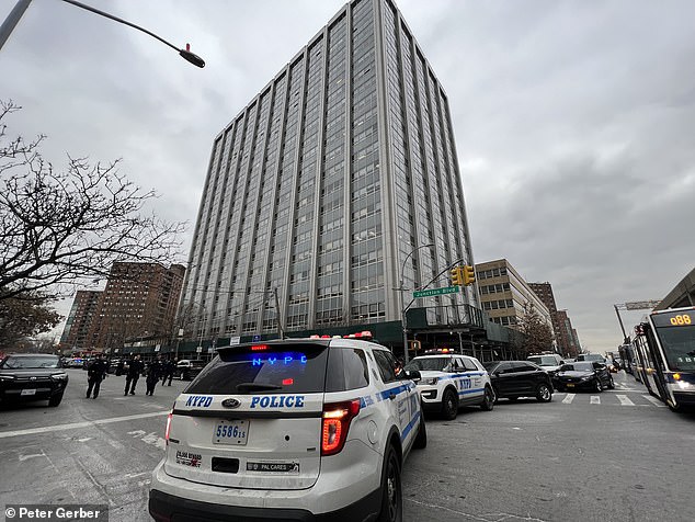 The scene outside the apartment building in Queens on Tuesday afternoon.