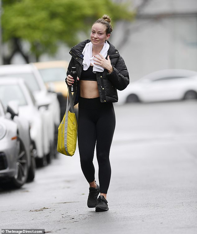 Oh fabulous!  He showed off his trim midsection in a black sports bra and leggings.