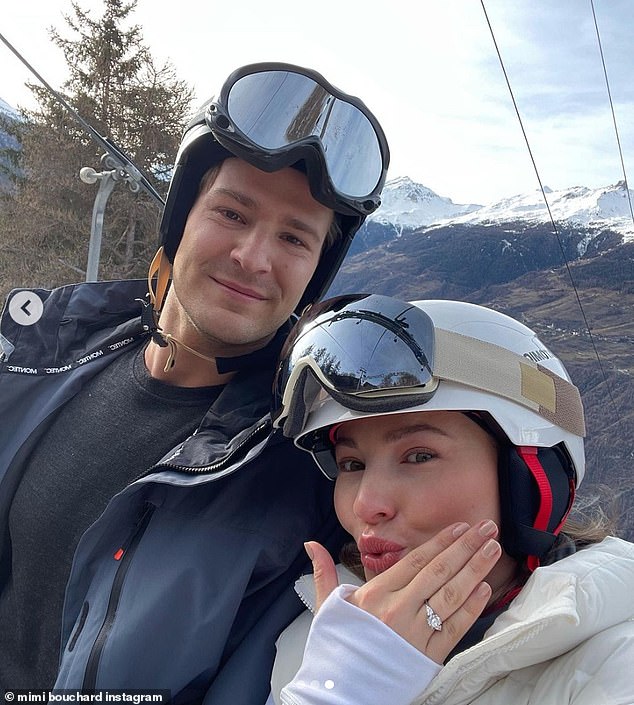 Loved up!  Mimi took the opportunity to show off her ring while she was sitting on a chairlift next to her fiancée.