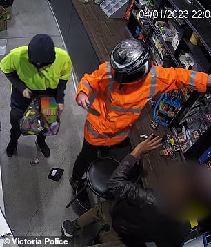 Throughout the robbery, the man in orange pointed a knife at the gas station worker.