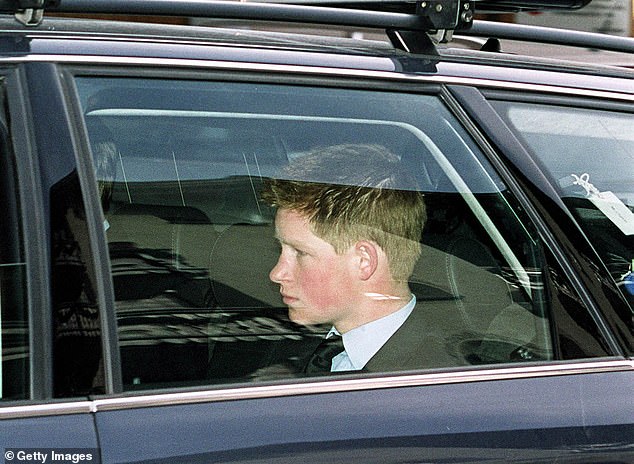 Prince Harry sits in a car as he and his brother Prince William and their father Prince Charles return home from a ski trip in Klosters.