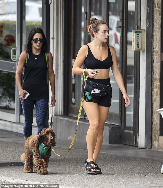 Wearing high-waisted shorts and a fitted crop top, the blonde bombshell slipped a Nike pack around her hips before slipping into a pair of comfortable black sandals.