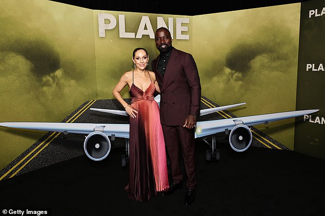 Mike and Iva: Butler's co-star Mike Colter stepped out in a black button-up dress shirt under a maroon coat, with matching maroon pants and black dress shoes.