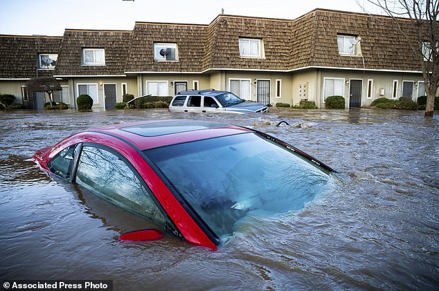 Flood course through a neighborhood in Merced, California on Tuesday
