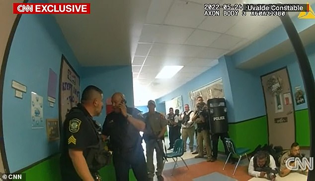 Arredondo directing heavily armed officers out of the classroom where the shooter hid