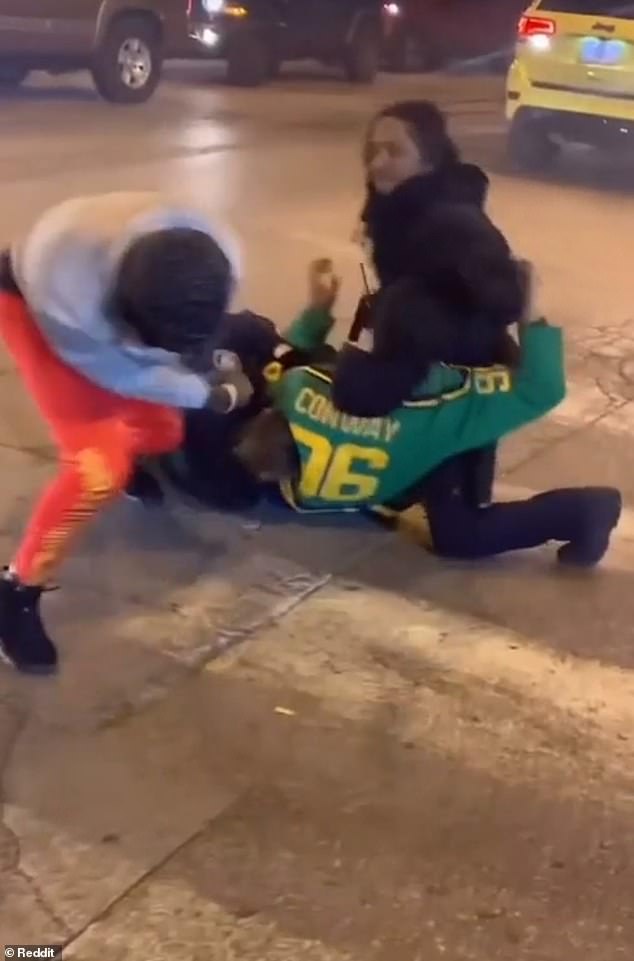 The video starts after the fight, so it's unclear how the fight starts, but the video shows two guards wrestling with a young man in a Disney's The Mighty Ducks hockey jersey.