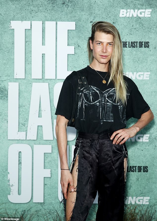 The influencer wore a graphic tee that he paired with ripped pants that showed off his muscular thighs.