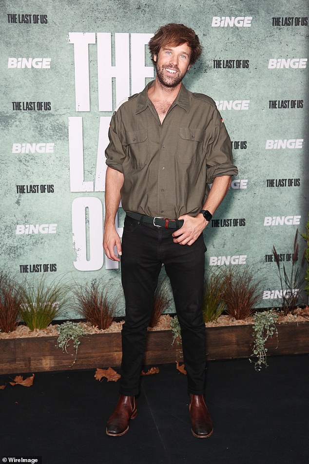 Danny Clayton looked handsome in a brown button down shirt and a pair of black jeans.