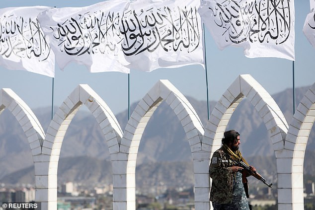 A Taliban fighter is seen at the Taliban flag raising ceremony in Kabul, Afghanistan, March 31, 2022