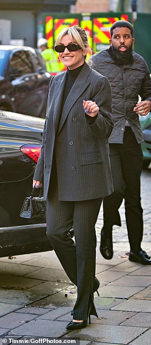 Smart: His look was a bit more conservative, opting for a pinstripe suit that came with an oversized blazer.