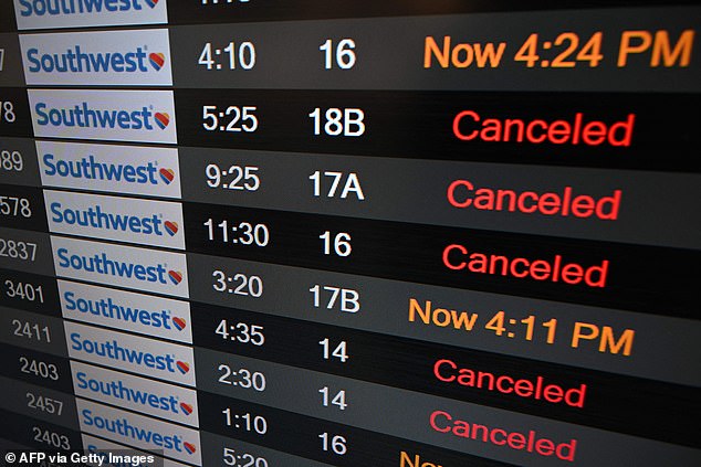 In this file photo taken on December 28, 2022, a screen shows canceled flights in the Southwest Airlines baggage area at Los Angeles International Airport.  The airline holiday travel crash occurred just before the blackout this morning.