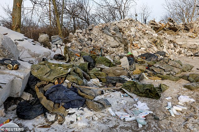 A view shows military uniform amid debris of a destroyed building purported to be a vocational college used as temporary accommodation for Russian soldiers