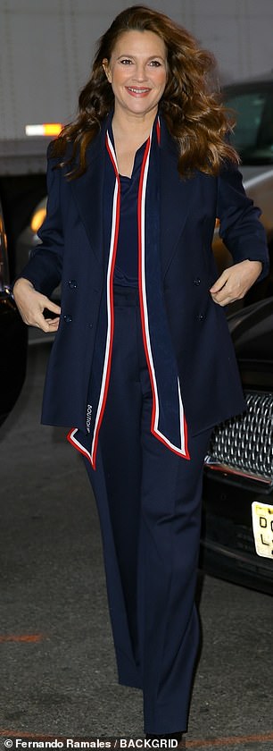 Looking fab: The 47-year-old showbiz legacy dressed in a navy Moschino pantsuit accessorized in a red and white scarf for a touch of patriotic flair