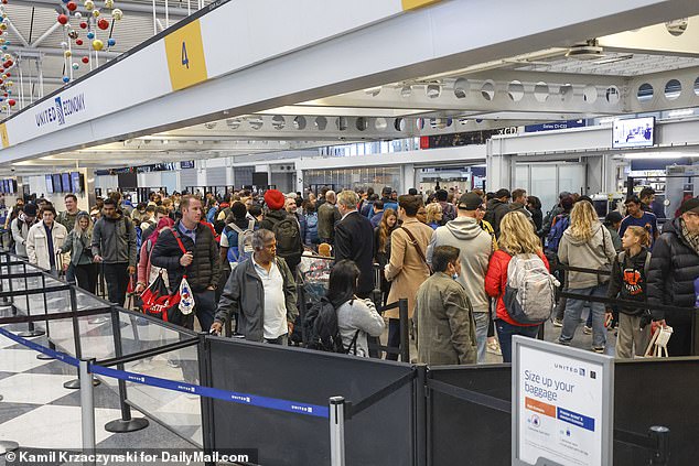 Travelers wait in the long line at the TSA checkpoint at United Airlines Terminal 1 at O'Hare International Airport on Wednesday.