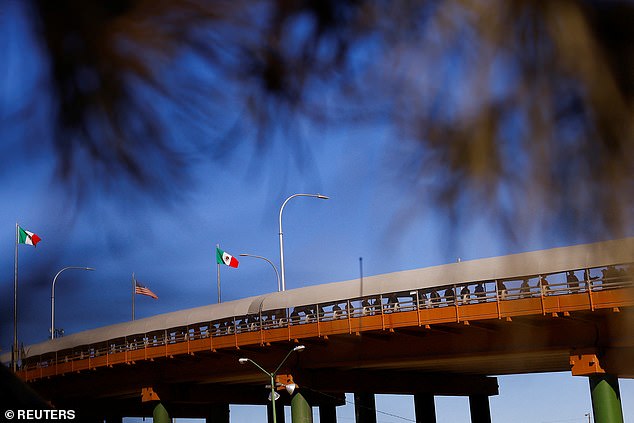 A long line of migrants, mostly from Venezuela and Cuba, walk back to Mexico after being removed from the US under Title 42 on January 9.