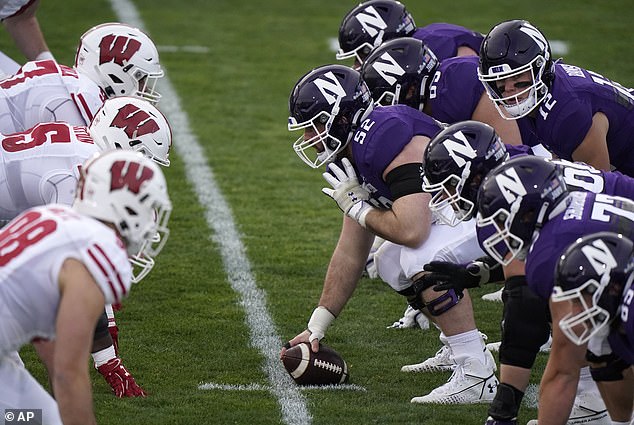 Northwestern's football team lines up against Wisconsion at the line of scrimmage