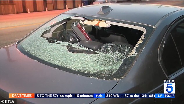 Another nearby car was damaged by falling rocks and debris.