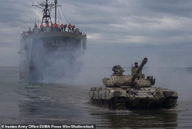 An Iranian tank is deployed on a beach from an Iranian Navy amphibious ship.