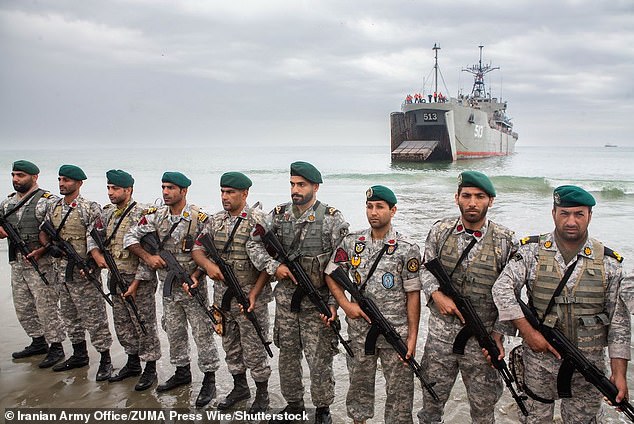 Iranian Navy soldiers stationed on a beach after being deployed from an amphibious landing ship